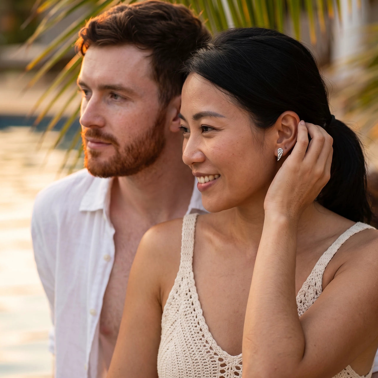 Woman gently touching her silver stud earrings | SKU: 42008-silver