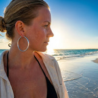 Thumbnail for Diamond Cut Statement Hoops in Silver, worn on the beach | SKU: 41009-silver