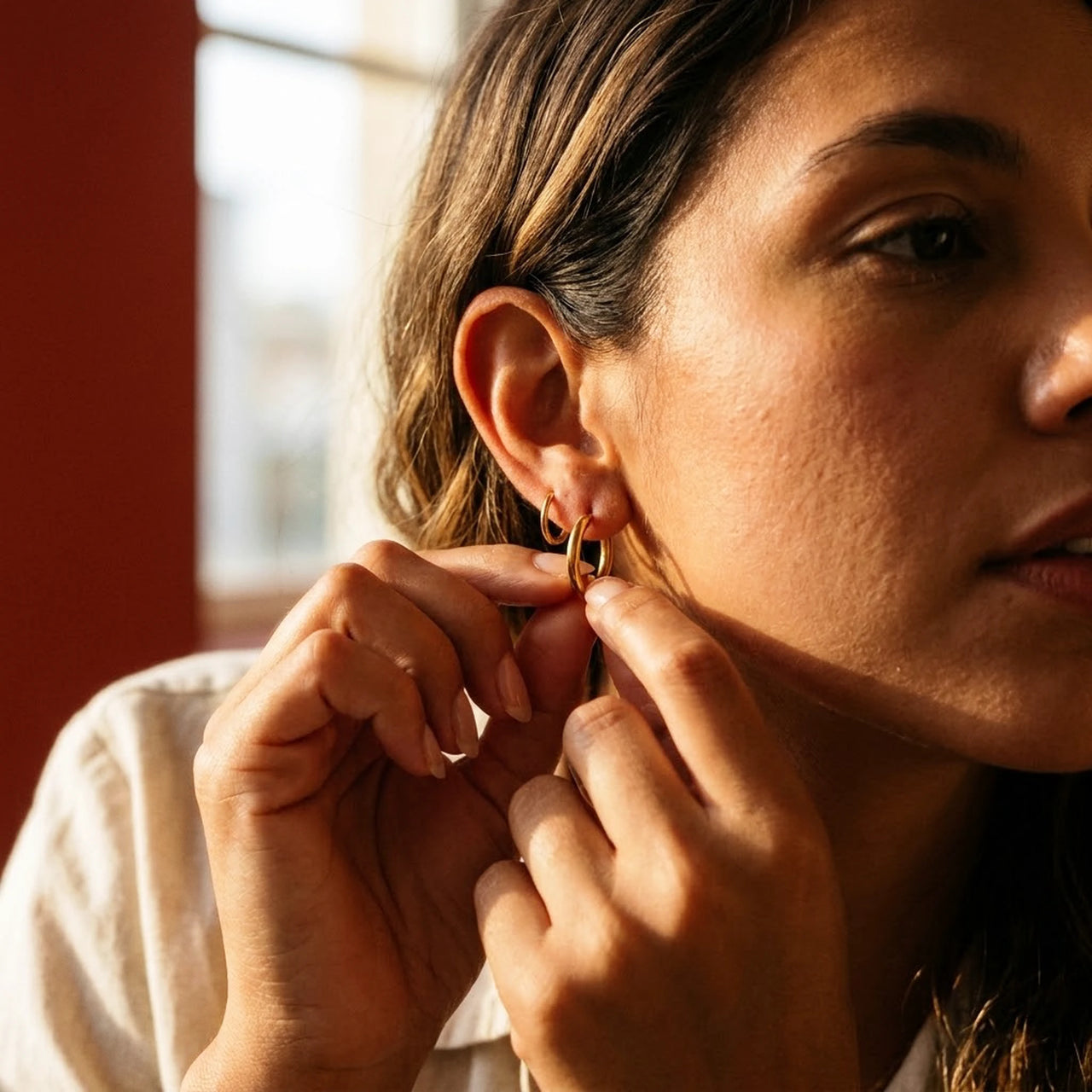 Everyday Waterproof Hoops in Gold, being put on | SKU: 41001-gold