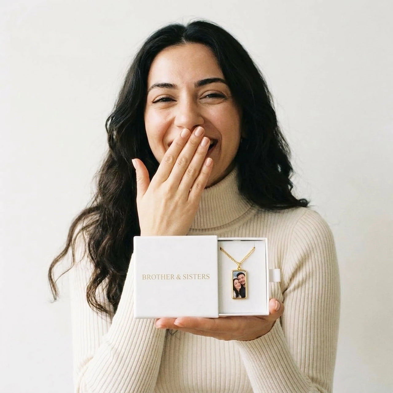 The gold bar photo necklace in the Brother & Sisters gift box, held in her palm | SKU: TPH-BARN-GOLD