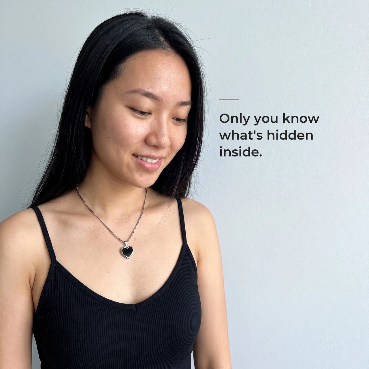 Woman wearing the silver heart pendant, black on the outside, only she knows the photo inside | SKU: TPH-CHTN-SILVER-SMALL