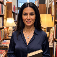 Thumbnail for Woman in a bookshop wearing the silver secret heart photo necklace | SKU: TPH-CHTN-SILVER-SMALL