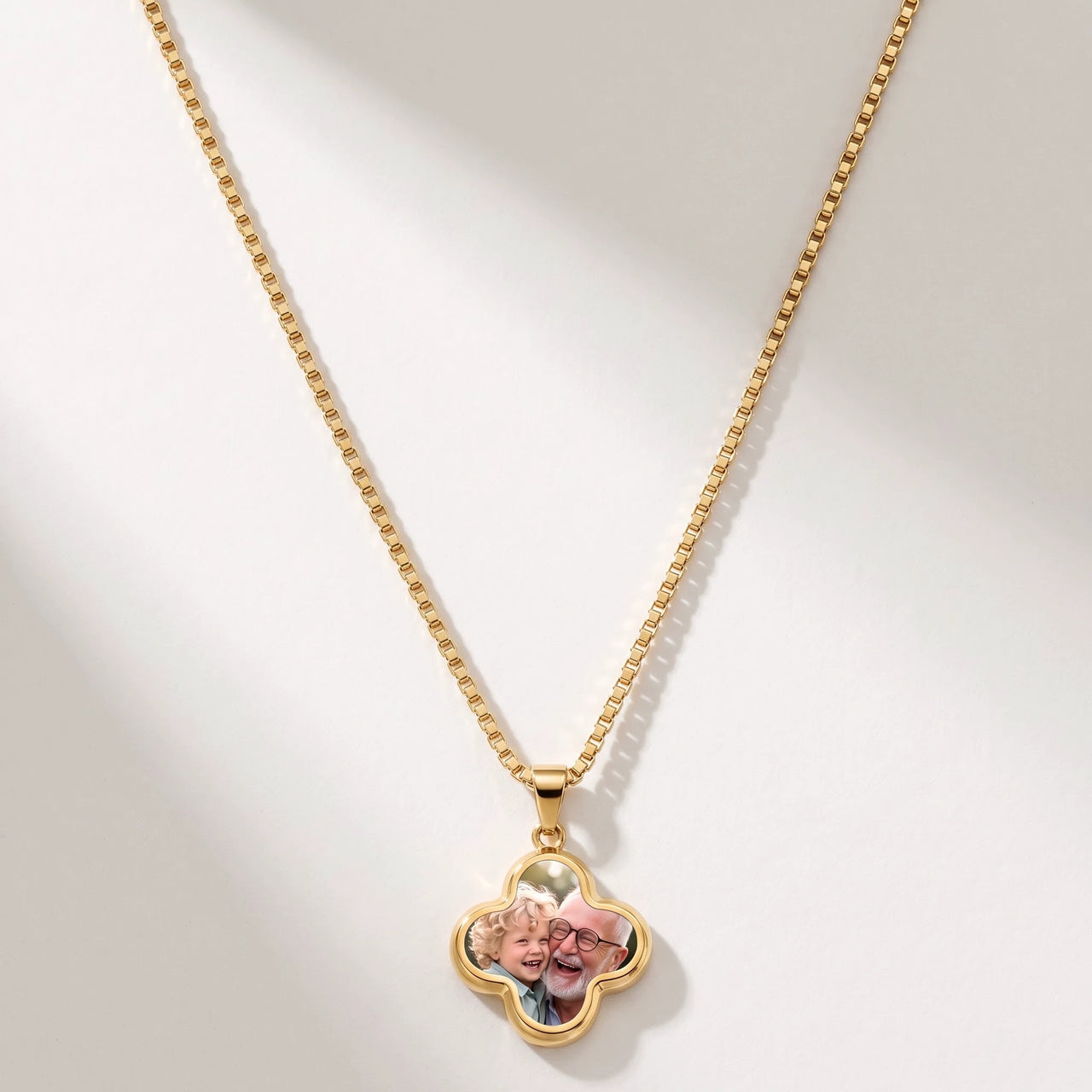 Secret Clover Photo Necklace in gold, four-leaf clover pendant on a box chain showing the hidden photo | SKU: TPH-CLVN-GOLD