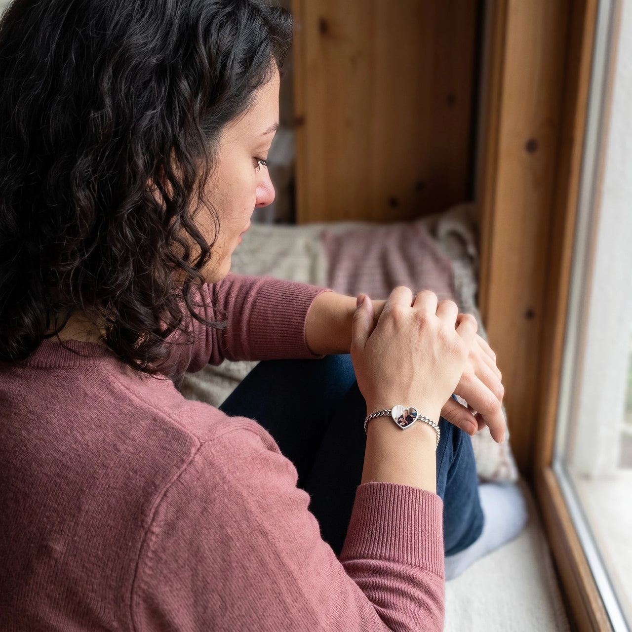 Woman looking at her grandmother's photo in the silver heart photo bracelet | SKU: TPH-HRTB-SILVER