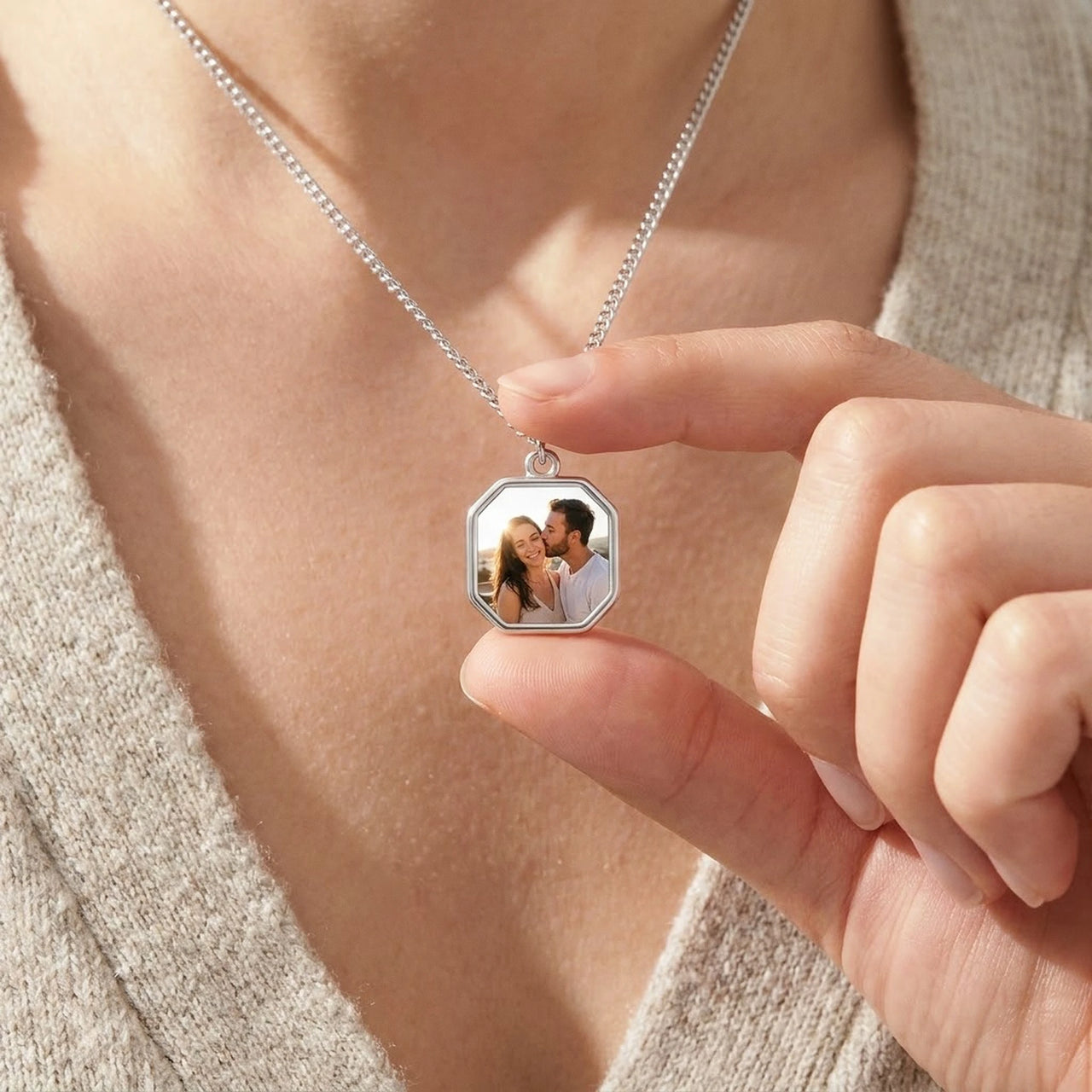 Looking down at the silver octagon pendant in her fingers, couple photo revealed | SKU: TPH-OCTN-SILVER